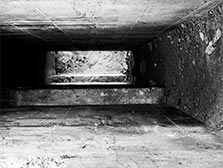 concrete walls looking downward into darkness