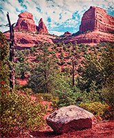 Sedona Arizona red rocks with a large boulder on the ground in front