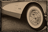 White eschelon of a Corvette with the front tire and hubcap